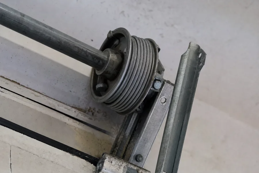 Lift cable wound onto its drum above a garage door in Denver, CO