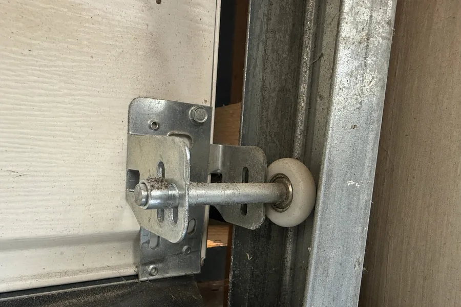 Garage door roller seated in its track in Denver, CO