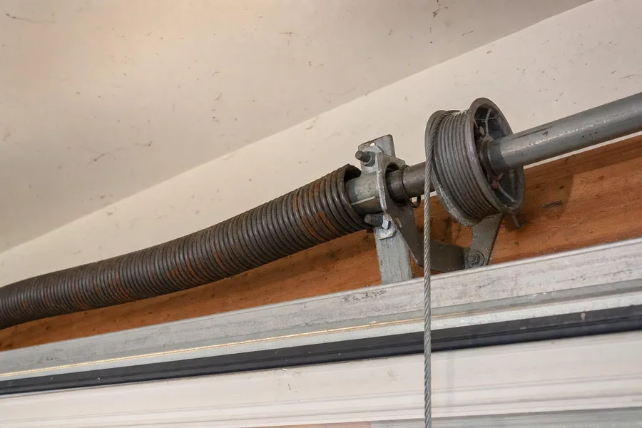 Torsion spring, shaft and cable drum above a garage door in Denver, CO